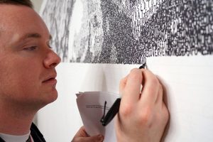Phil Hansen actively creating unique artwork with permanent marker.