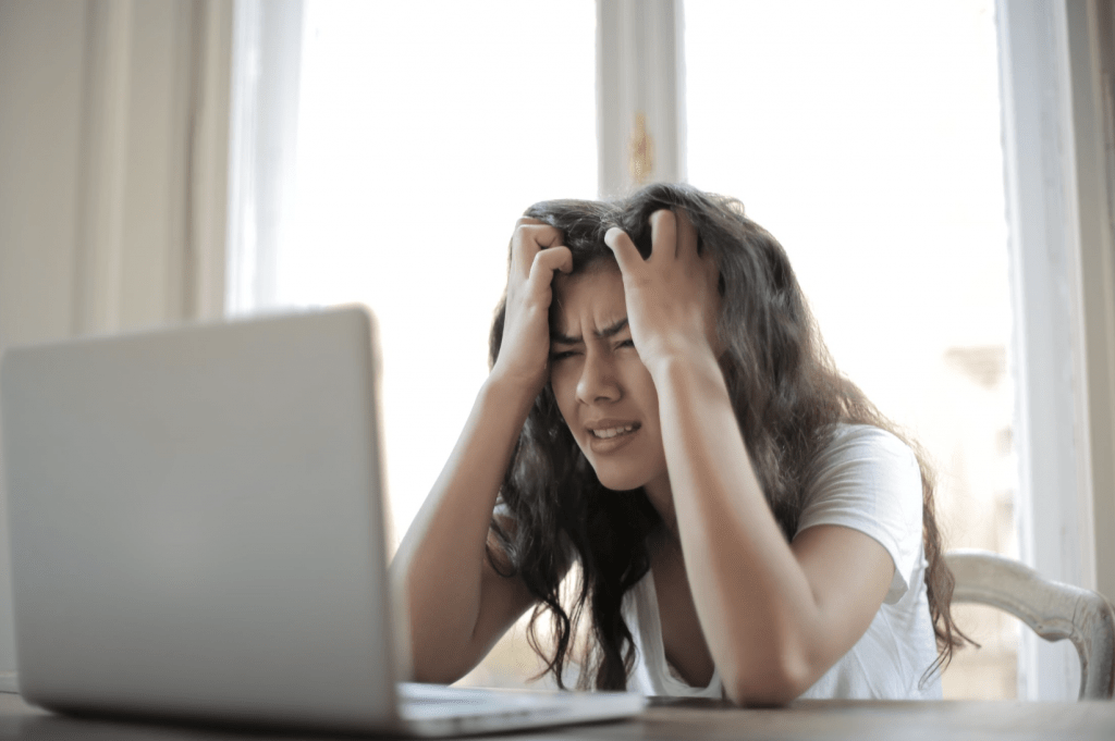 Stress Management woman stressed at table with laptop