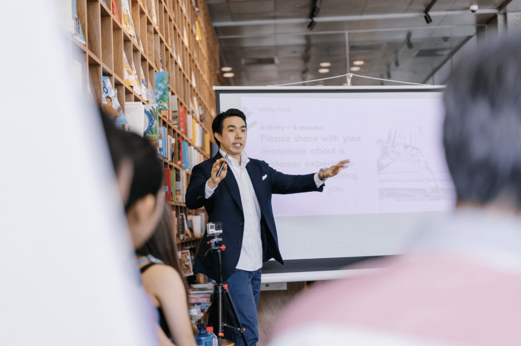 man giving keynote speech to audience