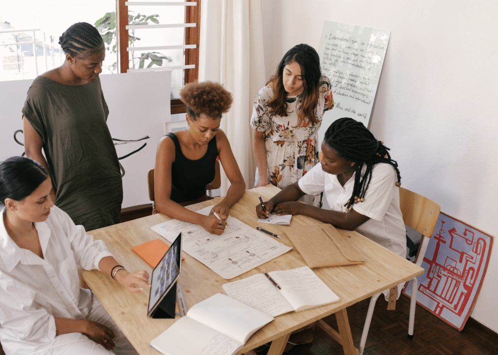 women sat at table planning on rebuilding employment